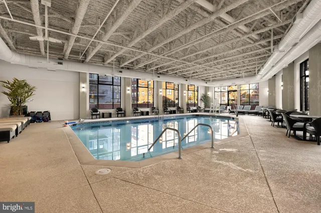 a swimming pool with outdoor seating