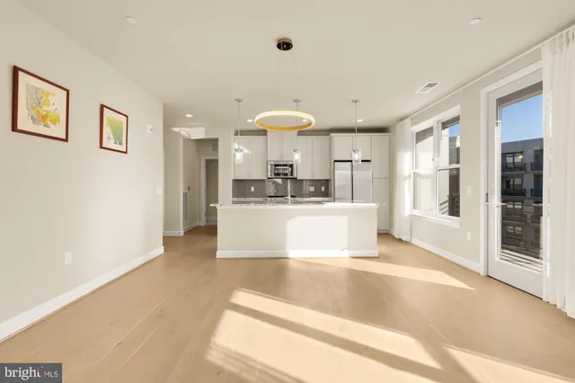 a view of a kitchen with a sink stainless steel appliances and cabinets