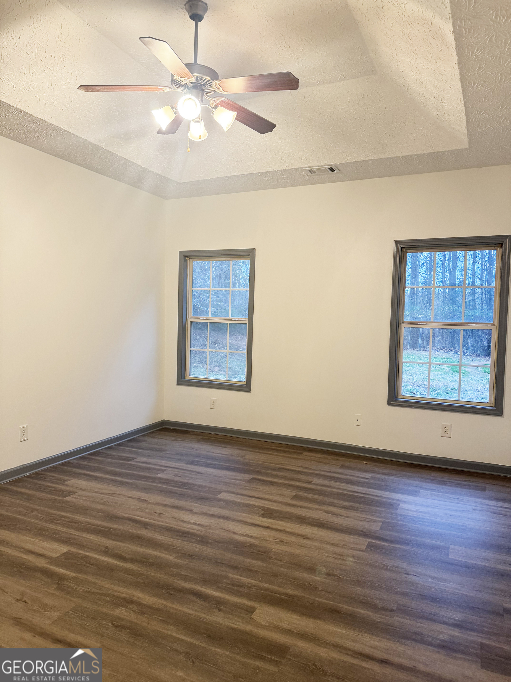 314 Hickory Road Jackson, GA 30233 - Photo 13 of 23 a view of an empty room with window and wooden floor