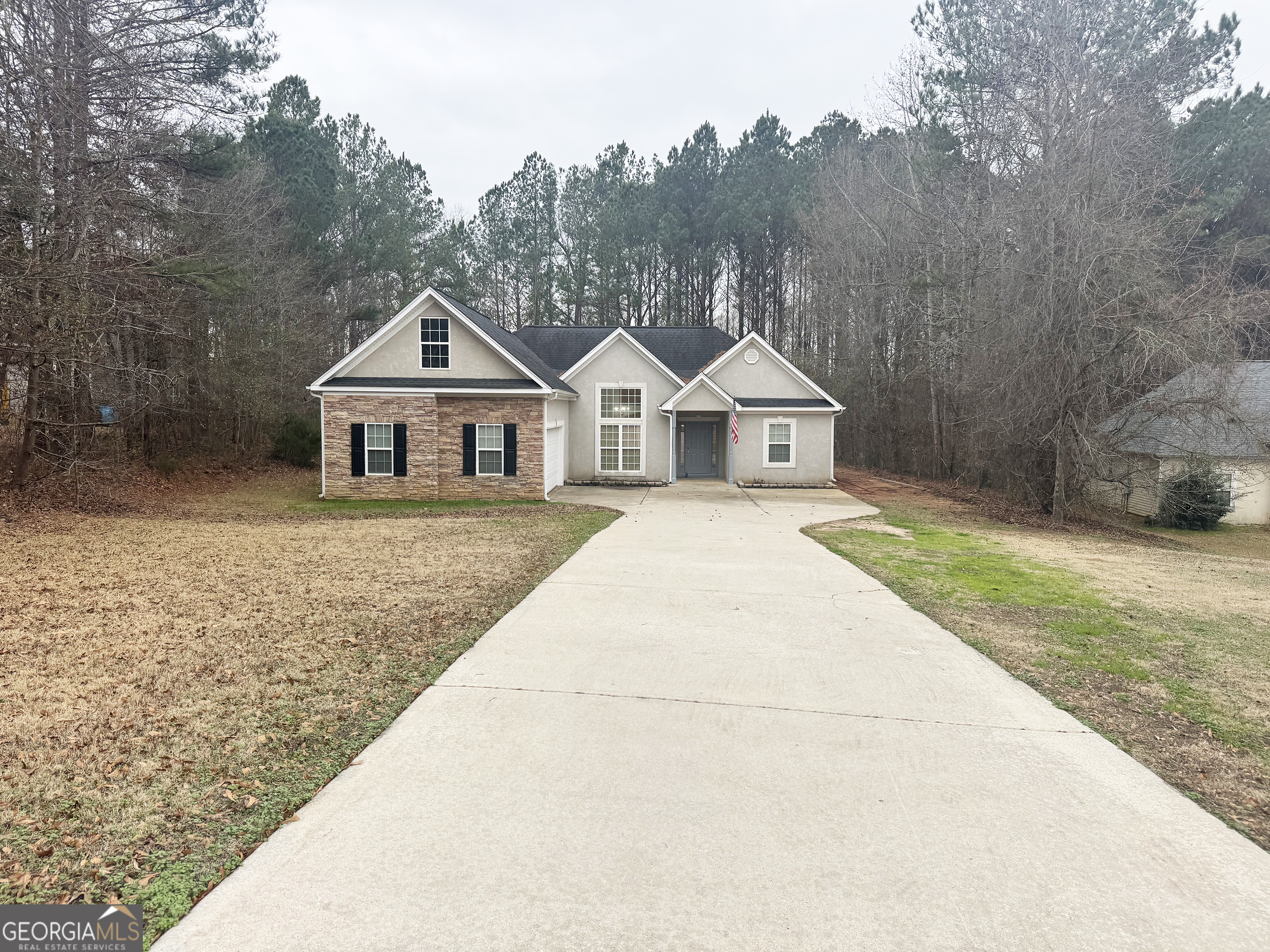 314 Hickory Road Jackson, GA 30233 - Photo 2 of 23 a view of a white house next to a yard with big trees