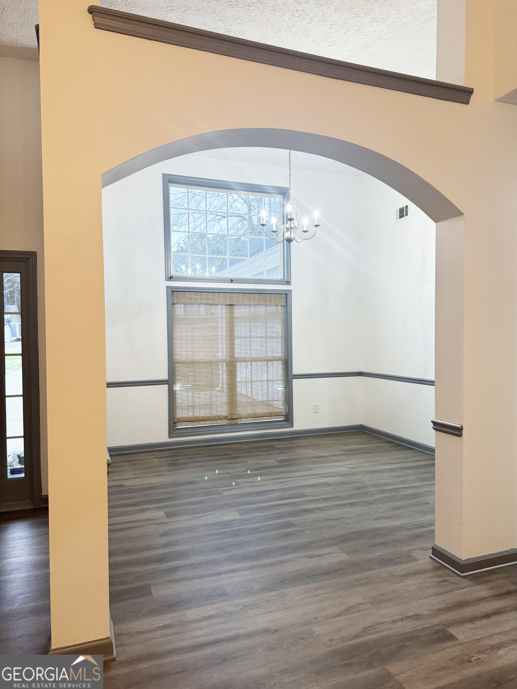 314 Hickory Road Jackson, GA 30233 - Photo 5 of 23 a view of an empty room with wooden floor and a window