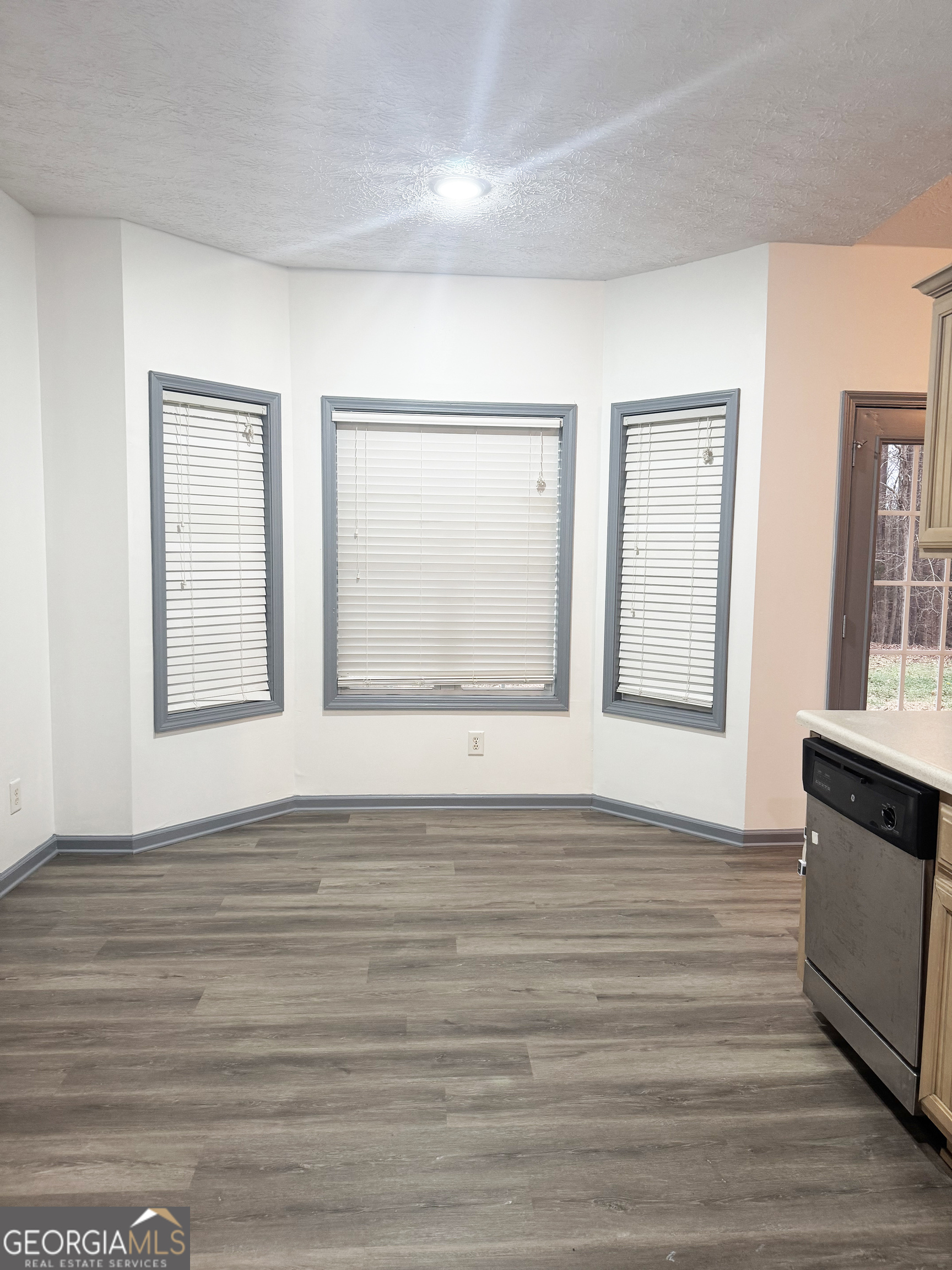 314 Hickory Road Jackson, GA 30233 - Photo 6 of 23 a view of an empty room with wooden floor and a window