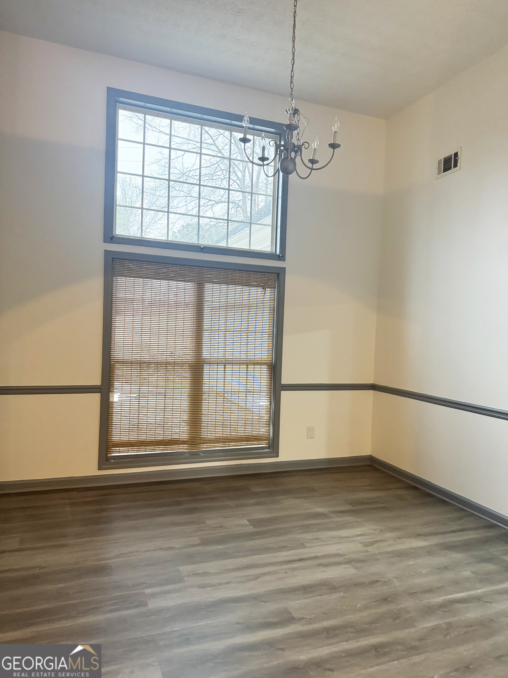 314 Hickory Road Jackson, GA 30233 - Photo 7 of 23 a view of an empty room with wooden floor and a window