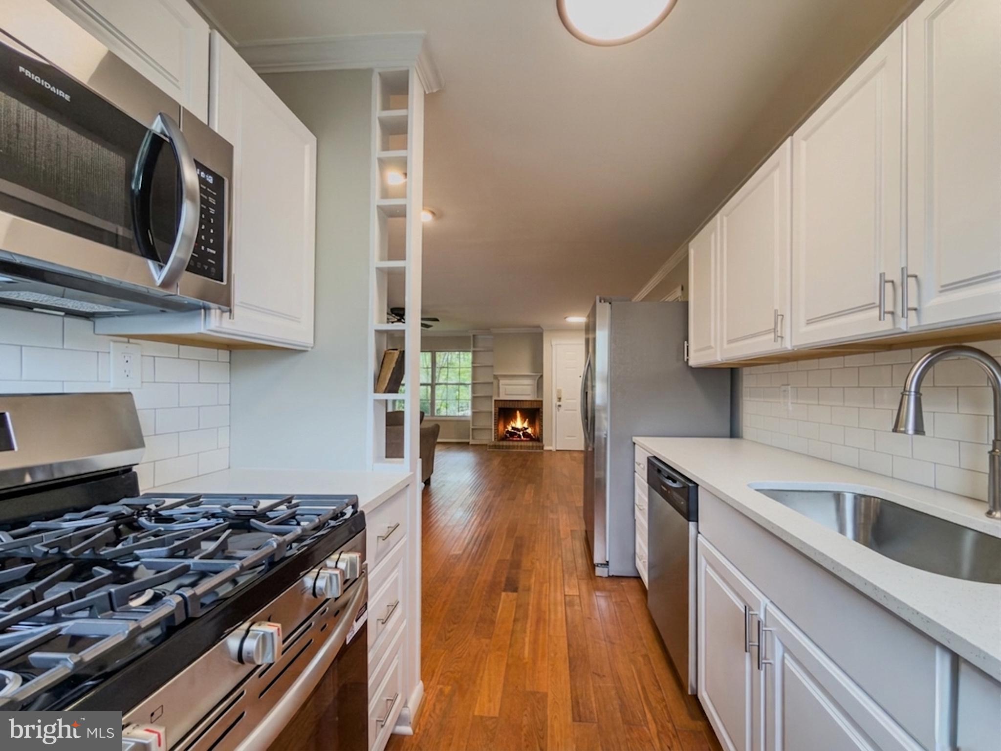 14900 Hydrus Road Silver Spring, MD 20906 - Photo 7 of 33 Modern kitchen with warm wood floors.