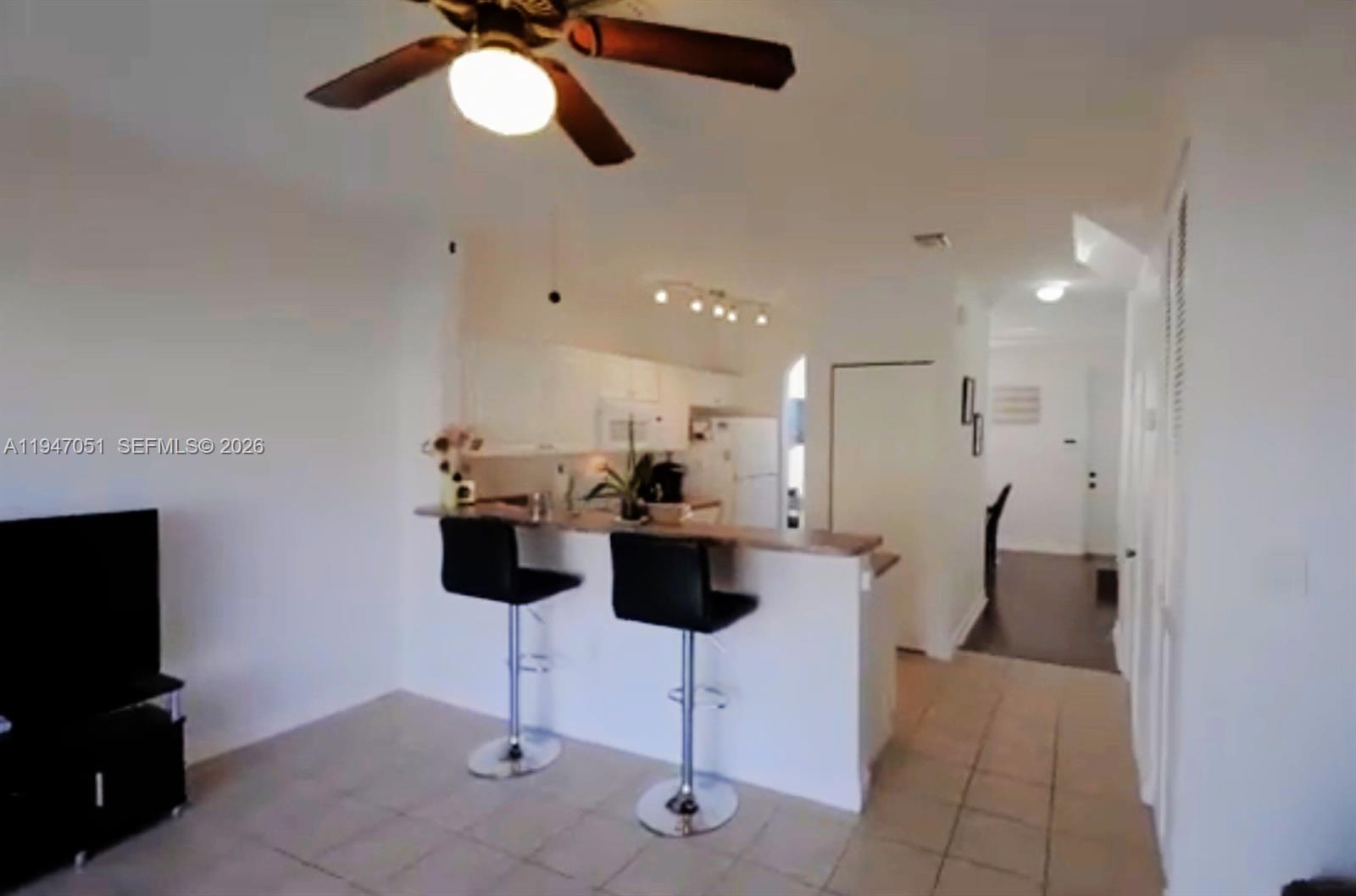1485 Northeast 33rd Road, Unit 1011 Homestead, FL 33033 - Photo 2 of 7 a view of dining room with furniture and chandelier