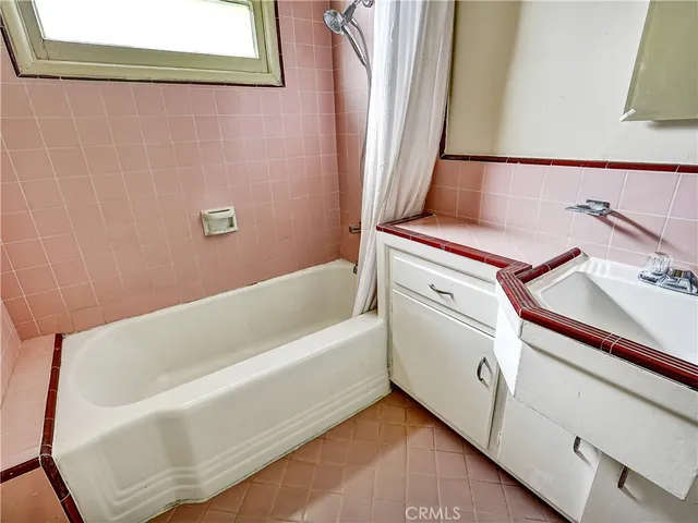 a bathroom with a bathtub and shower