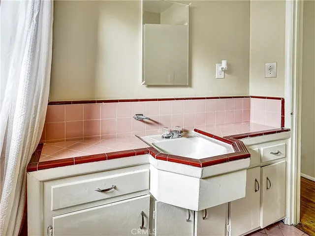 a bathroom with a sink and a mirror