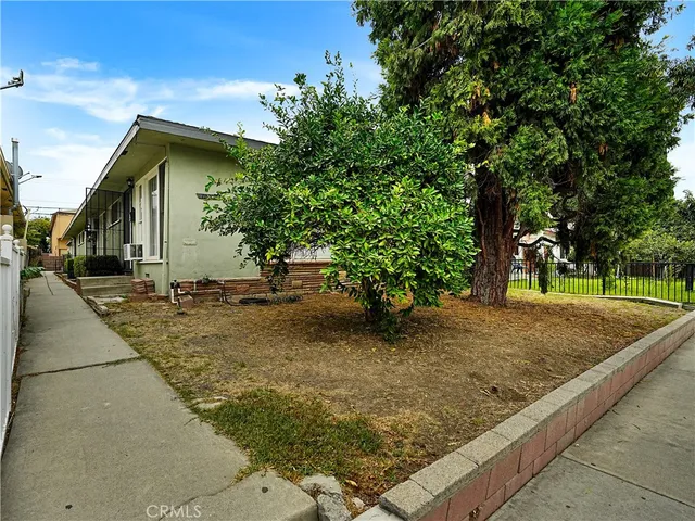 a backyard of a house with large trees