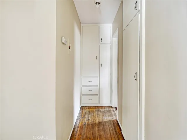 a view of a hallway with wooden floor