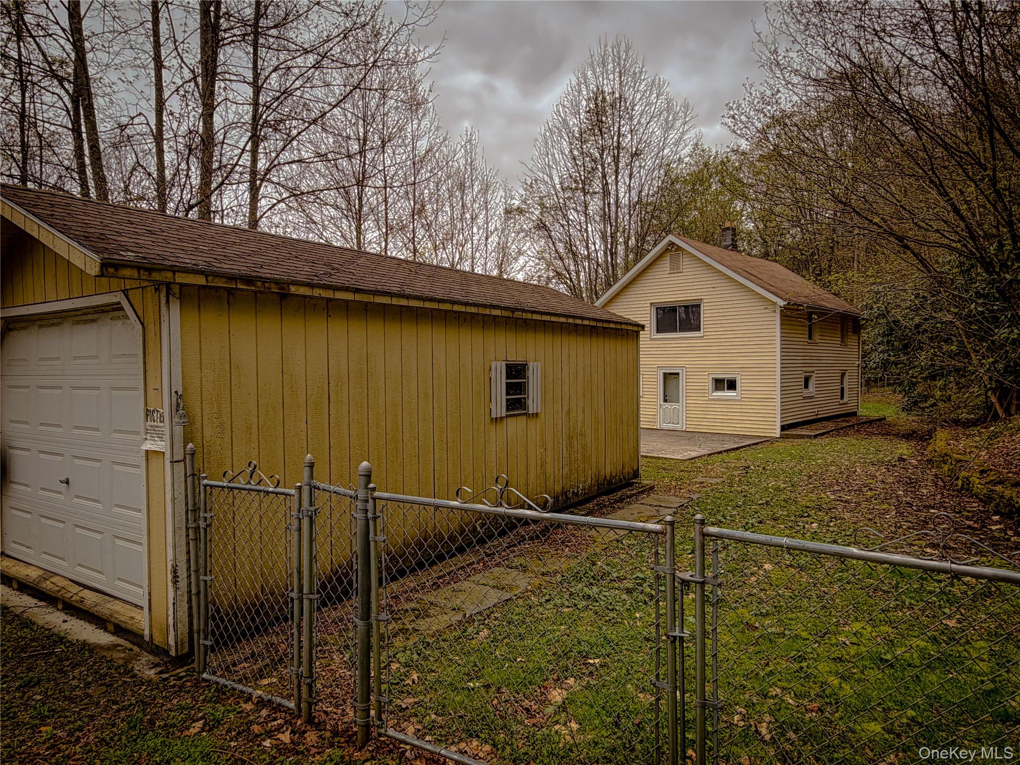 322 Peas Eddy Road Hancock, NY 13783 - Photo 6 of 7 Detached garage structure with a white overhead door and horizontal siding