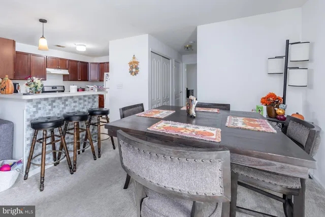 a kitchen with kitchen island a table and chairs in it
