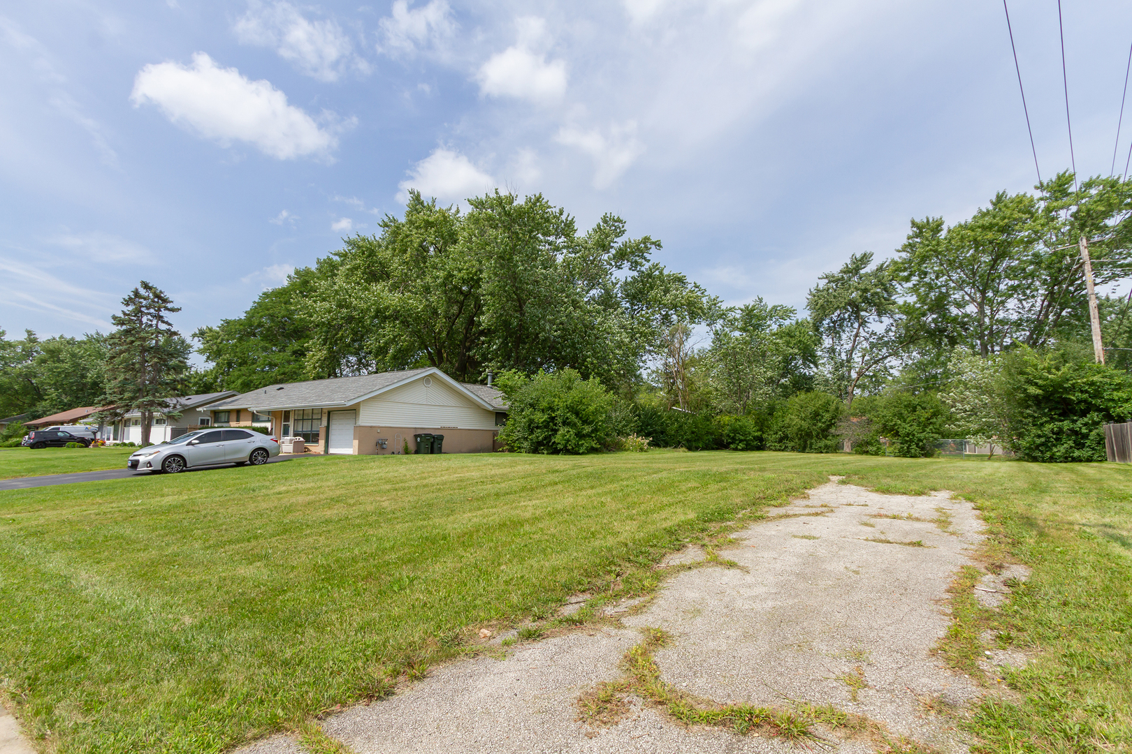 480 Illinois Boulevard Hoffman Estates, IL 60169 - Photo 3 of 3 a big house with lots of green space and trees in the background