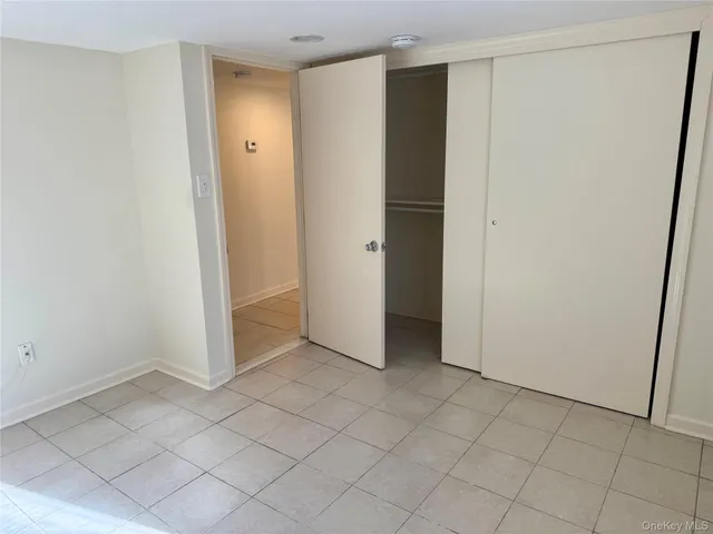 an empty room with closet area