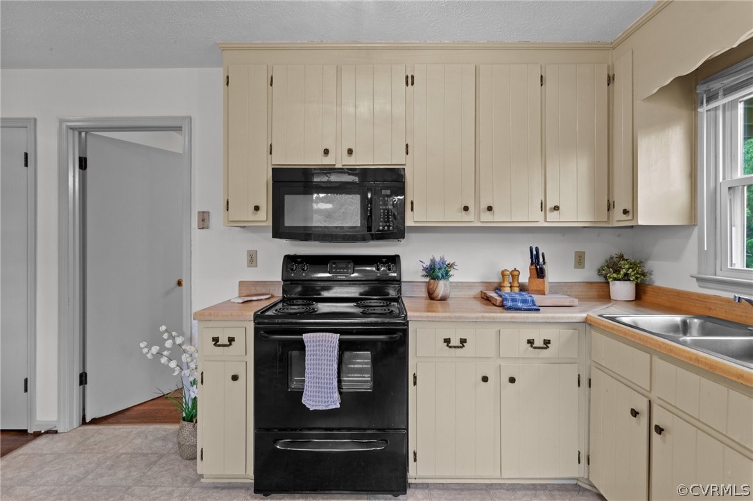 1692 Miller Lk Road Rice, VA 23966 - Photo 14 of 35 a kitchen with stainless steel appliances granite countertop a stove a microwave and a white cabinets
