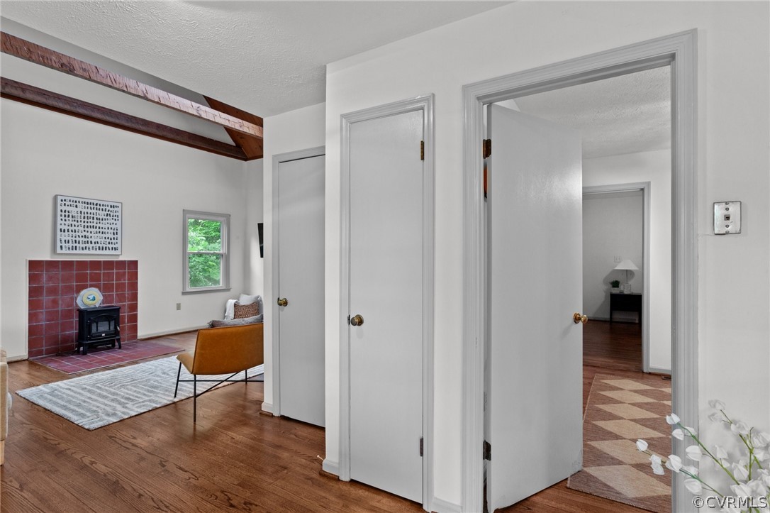 1692 Miller Lk Road Rice, VA 23966 - Photo 15 of 35 a view of a hallway with wooden floor and furniture and a fireplace