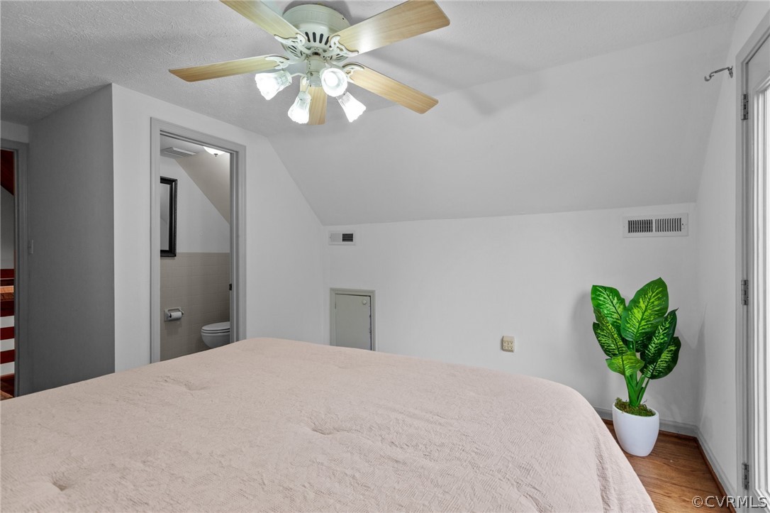 1692 Miller Lk Road Rice, VA 23966 - Photo 24 of 35 a bedroom with a bed chandelier and a chandelier