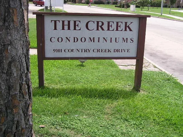 a sign broad in front of red brick house