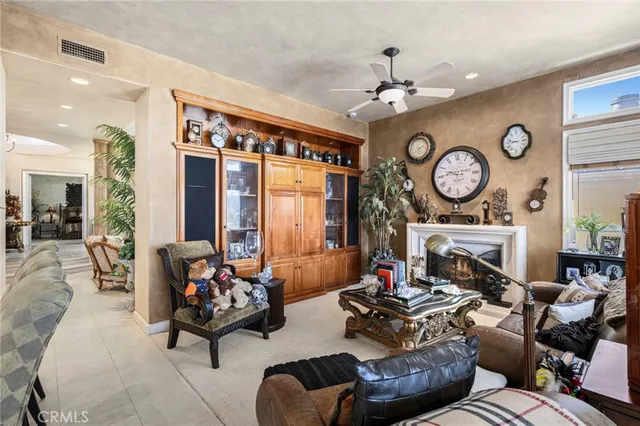 a living room with furniture a clock and a fireplace