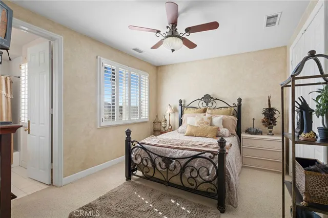 a bedroom with a bed a window and closet