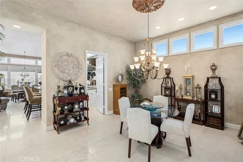 a view of a dining room with furniture and chandelier