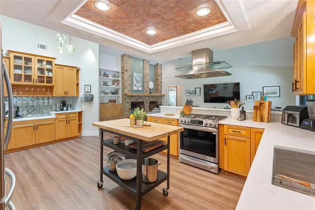 a kitchen with a sink appliances and wooden floor