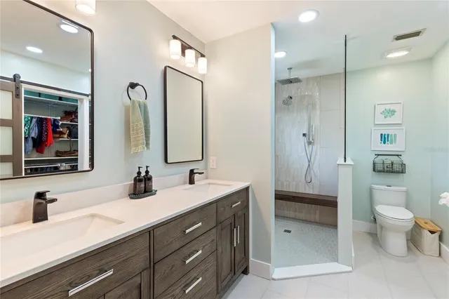 a bathroom with a double vanity sink and mirror