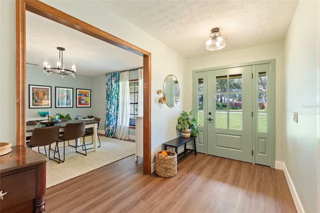 a view of a dining room with furniture wooden floor and a chandelier