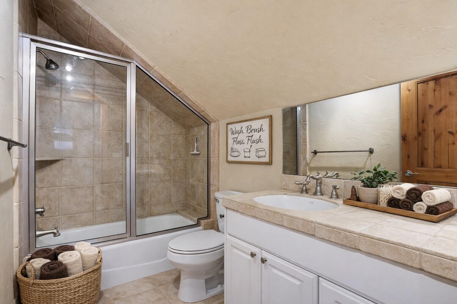 631 Sundance Ridge Court Redmond, OR 97756 - Photo 51 of 61 a bathroom with a granite countertop sink a toilet and shower