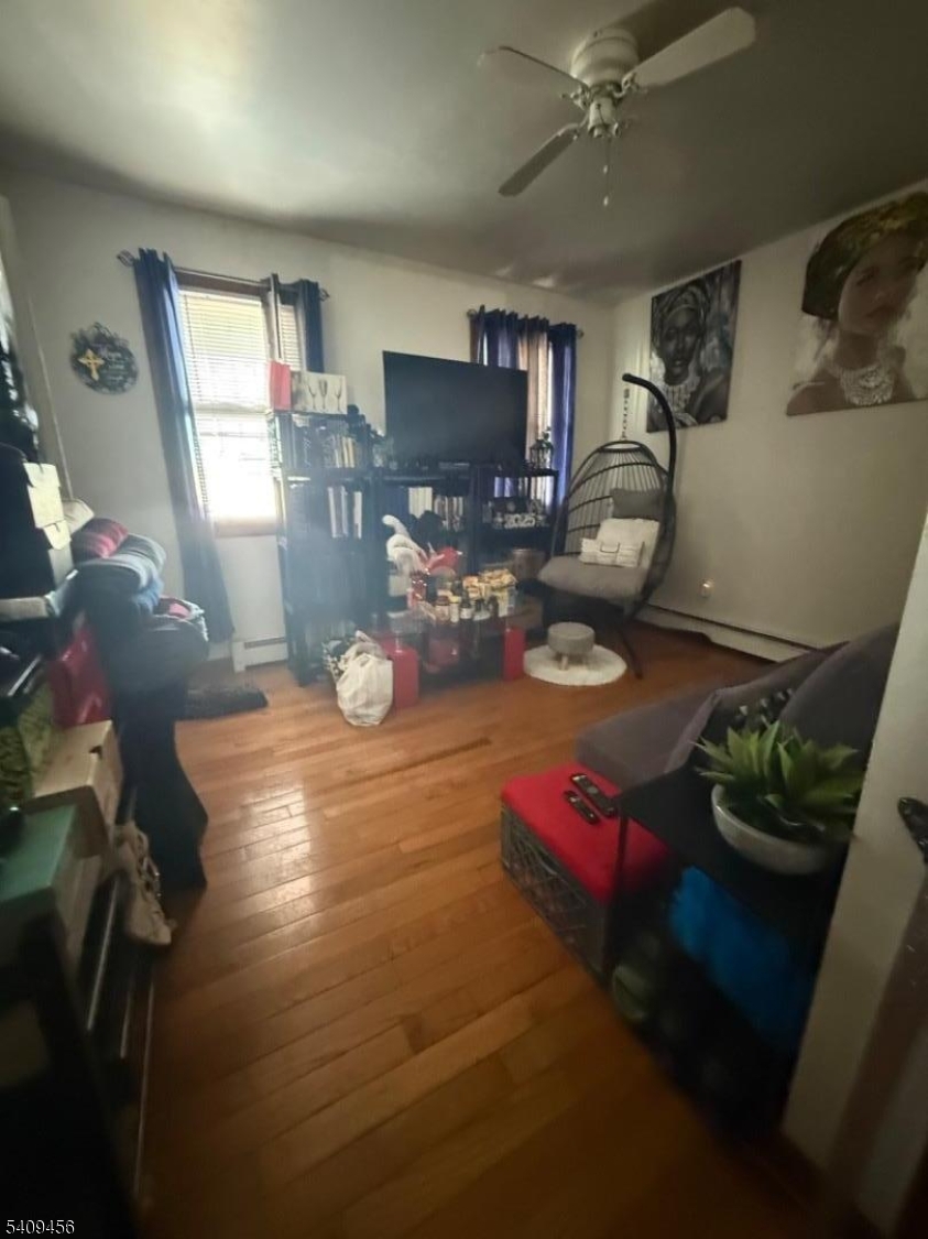 744 Trumbull Street Elizabeth, NJ 07201 - Photo 12 of 13 a living room with furniture and a flat screen tv