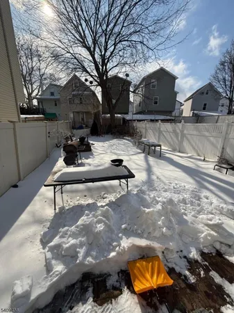 a view of a chairs and fire pit in the back yard