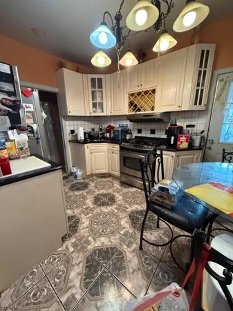 a kitchen with stainless steel appliances granite countertop a sink a stove and a wooden floors