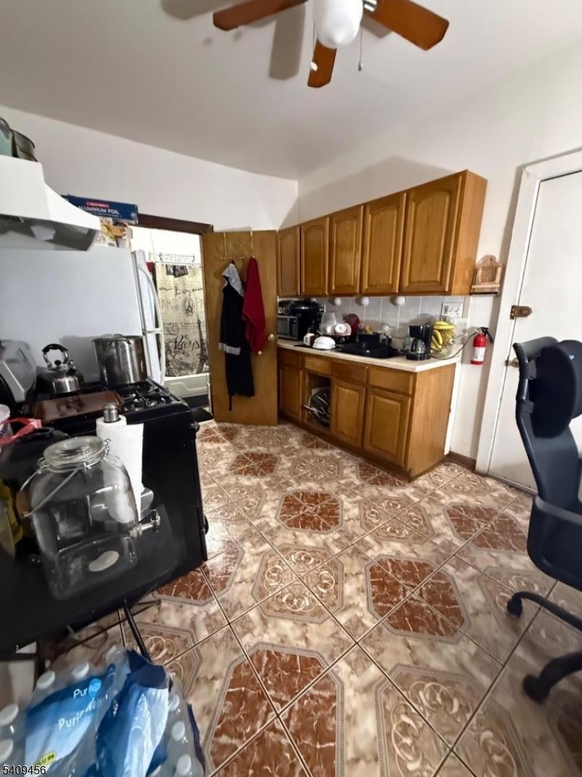 744 Trumbull Street Elizabeth, NJ 07201 - Photo 10 of 13 a kitchen with a sink and a stove top oven