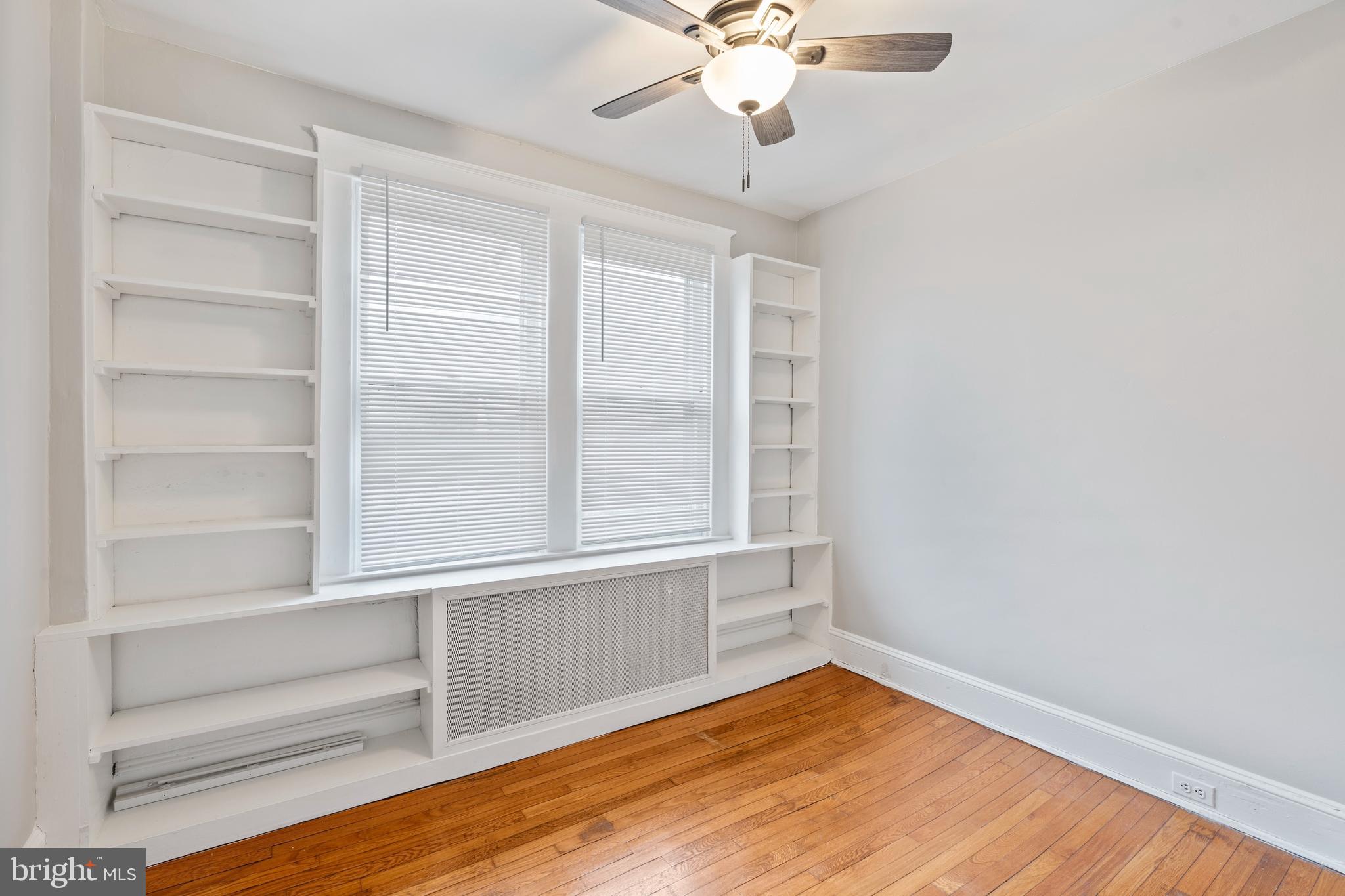 639 Plymouth Road Baltimore, MD 21229 - Photo 12 of 16 a view of an empty room with a window and wooden floor