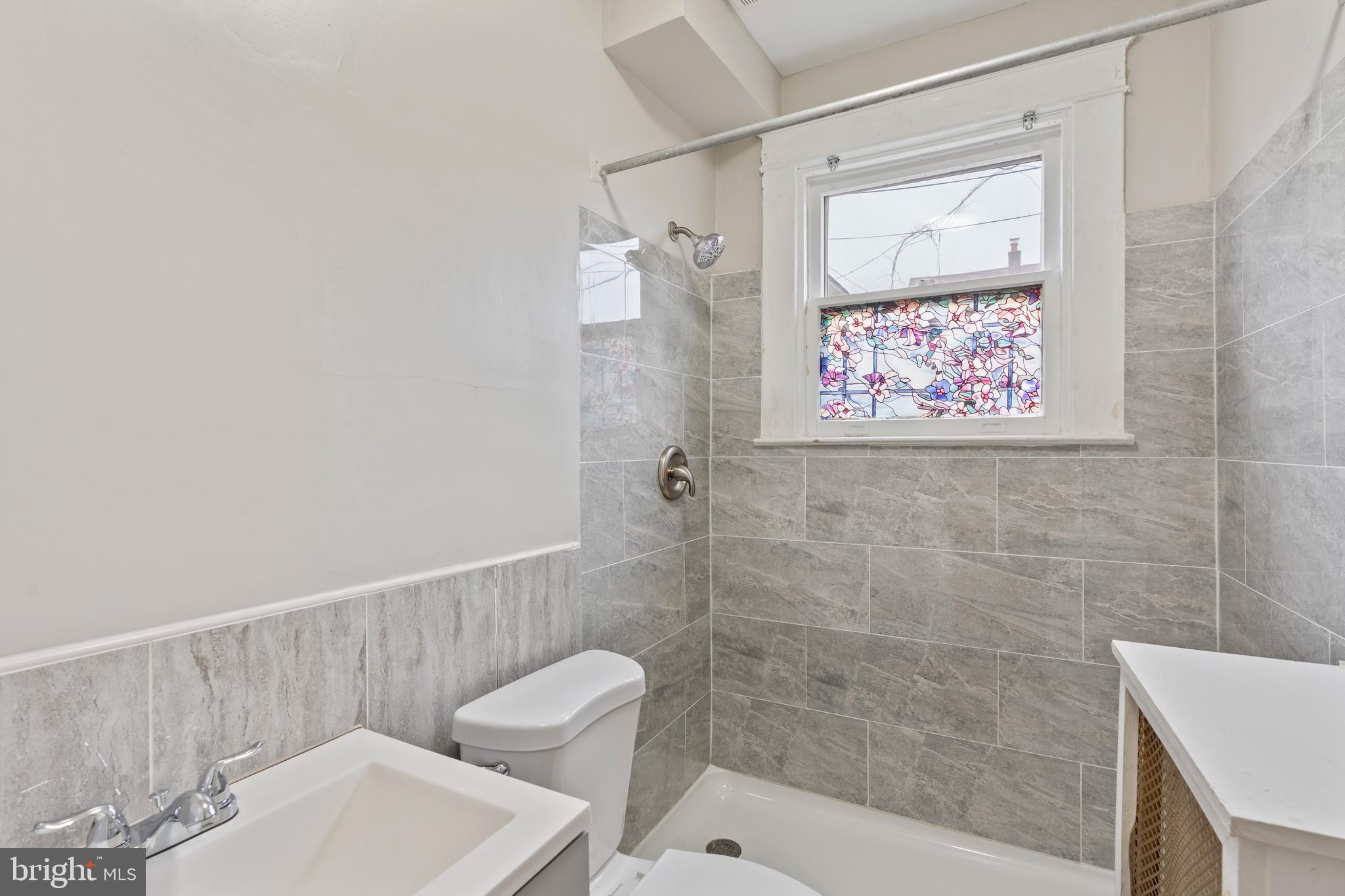639 Plymouth Road Baltimore, MD 21229 - Photo 14 of 16 a bathroom with a toilet and a shower