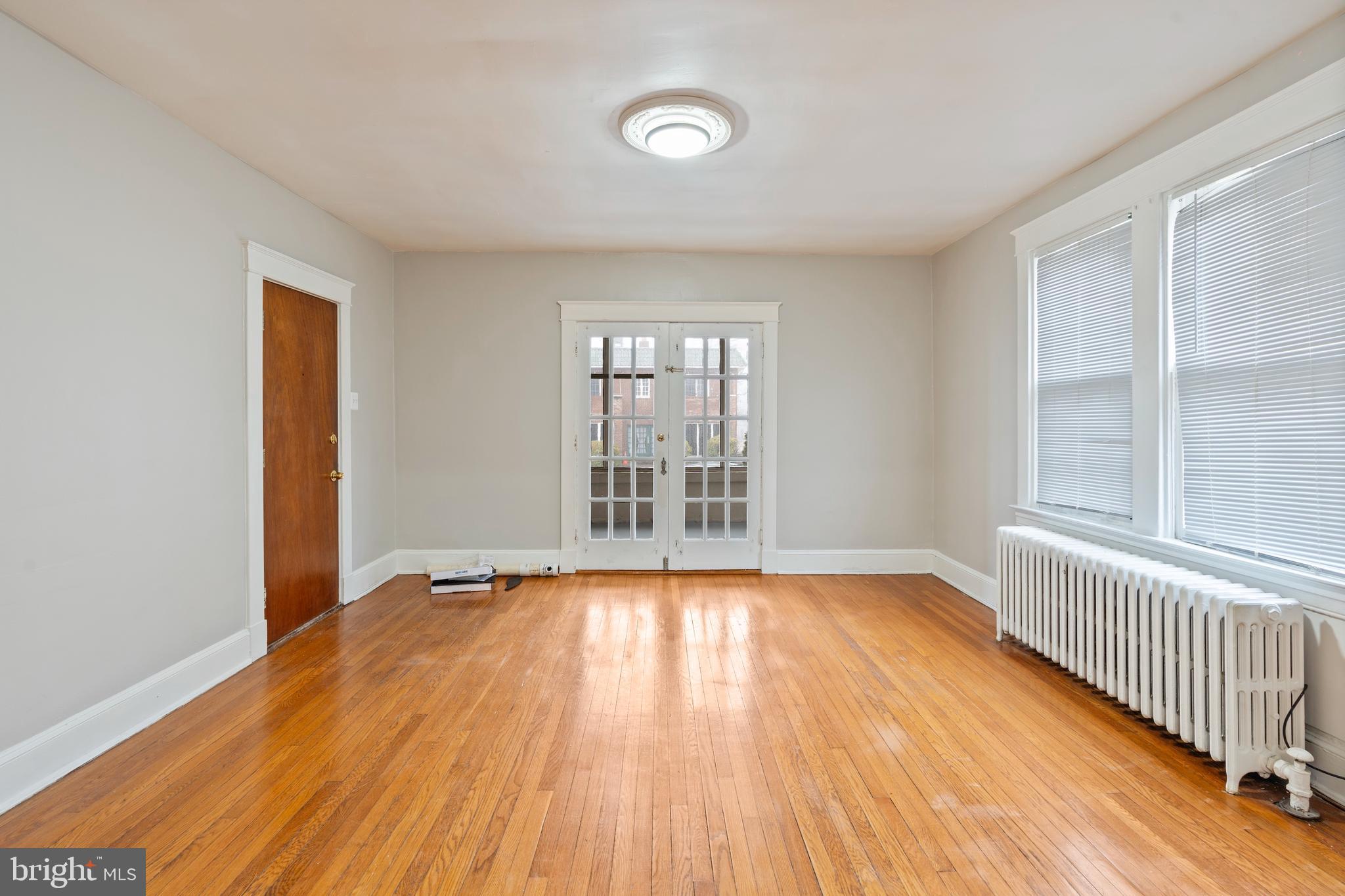 639 Plymouth Road Baltimore, MD 21229 - Photo 4 of 16 a view of an empty room with wooden floor and a window