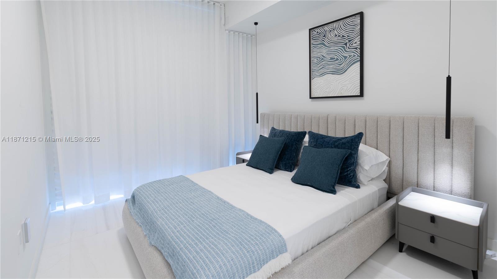 300 Biscayne Blvd Way, Unit 503C Miami, FL 33131 - Photo 29 of 64 a bedroom with a bed and a night stand