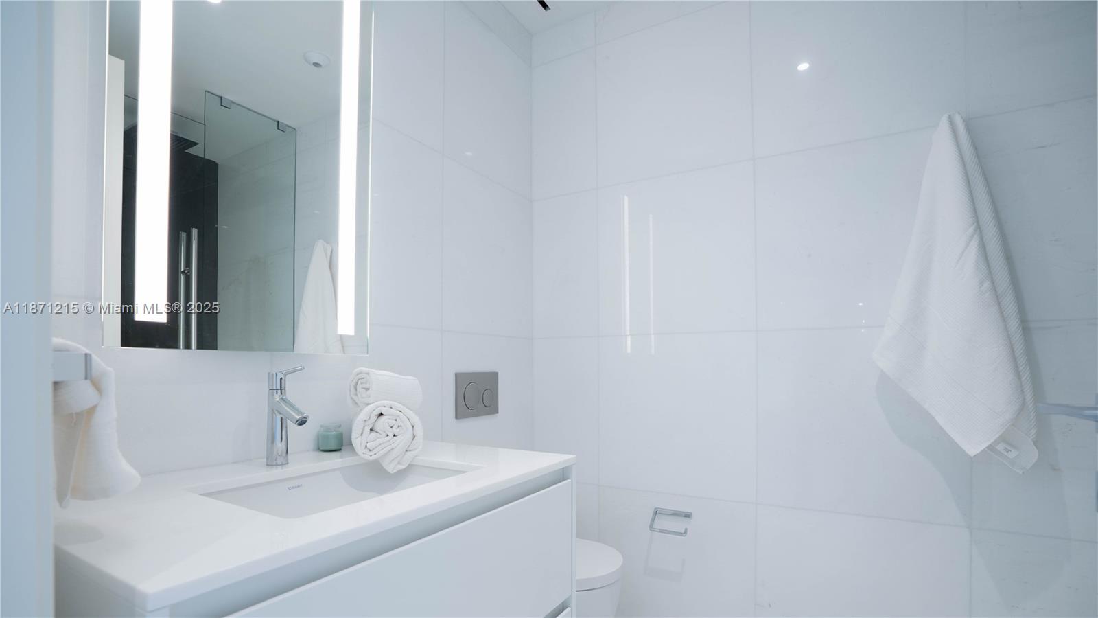 300 Biscayne Blvd Way, Unit 503C Miami, FL 33131 - Photo 35 of 64 a bathroom with a sink and a mirror