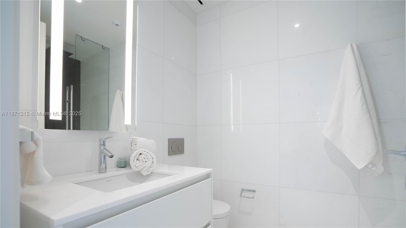 300 Biscayne Blvd Way, Unit 503C Miami, FL 33131 - Photo 36 of 64 a bathroom with a sink toilet and mirror