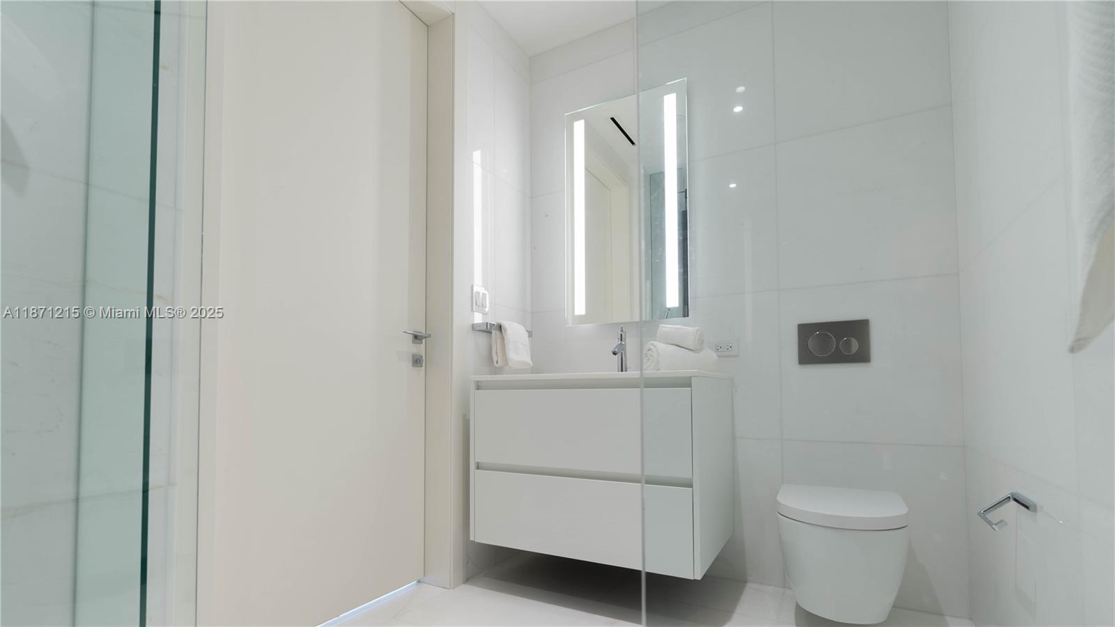 300 Biscayne Blvd Way, Unit 503C Miami, FL 33131 - Photo 37 of 64 a bathroom with a toilet sink and mirror