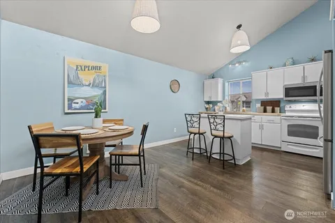 a kitchen with stainless steel appliances a stove a microwave and sink