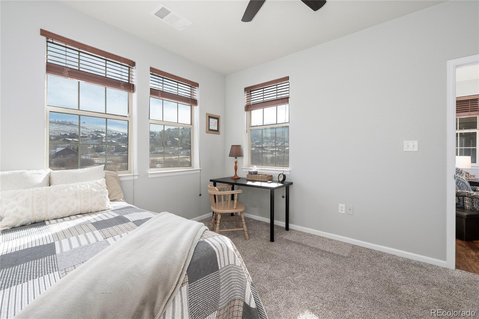 154 Village Road, Unit C103 Granby, CO 80446 - Photo 11 of 39 a bedroom with a bed and a table