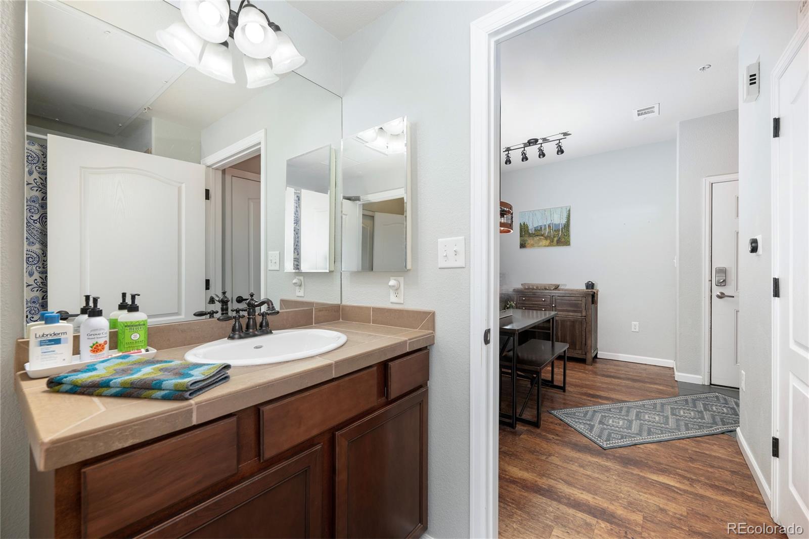 154 Village Road, Unit C103 Granby, CO 80446 - Photo 12 of 39 a en suite bathroom with a double vanity sink a mirror and a shower
