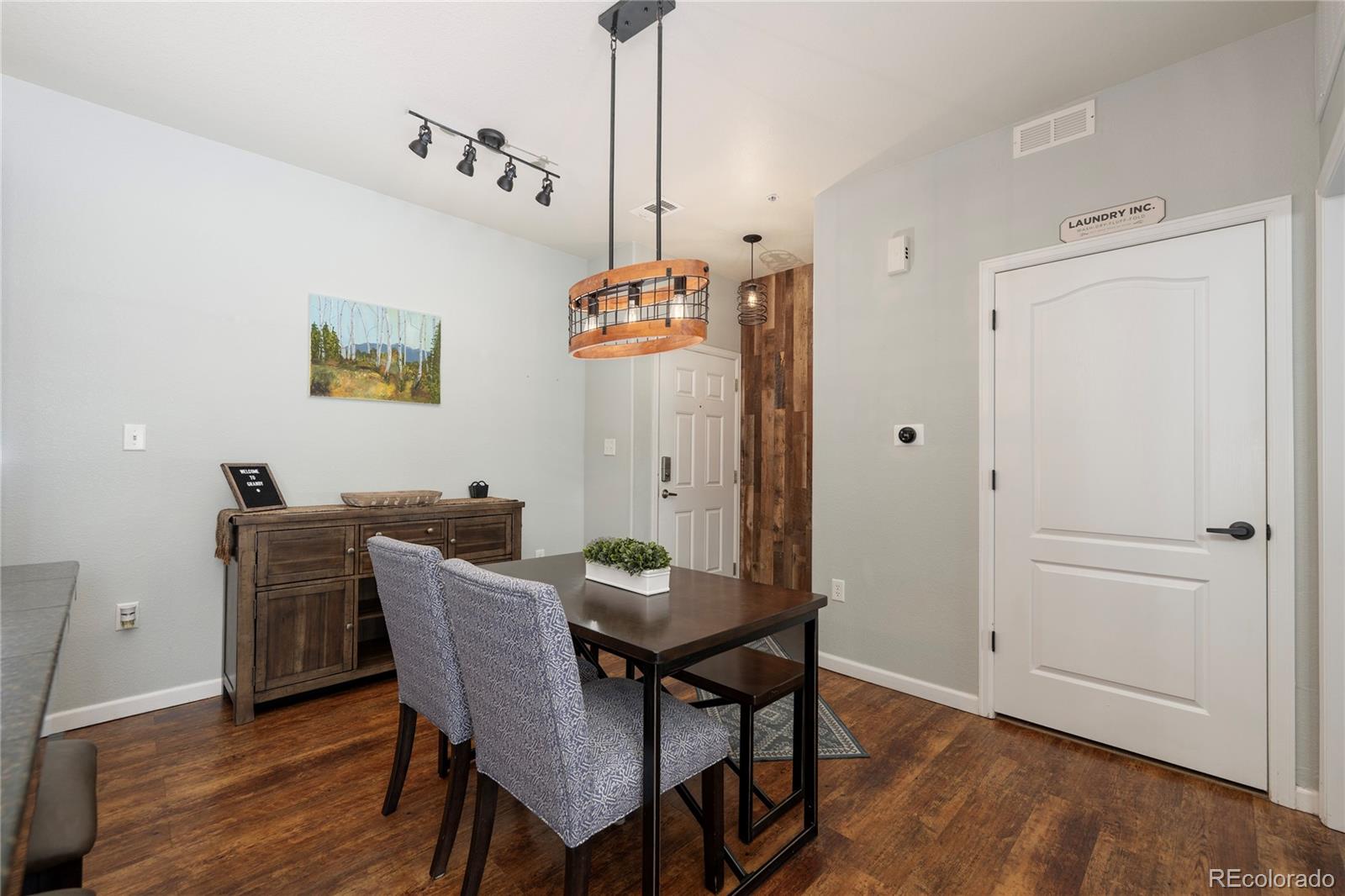 154 Village Road, Unit C103 Granby, CO 80446 - Photo 14 of 39 a view of a dining room with furniture and wooden floor