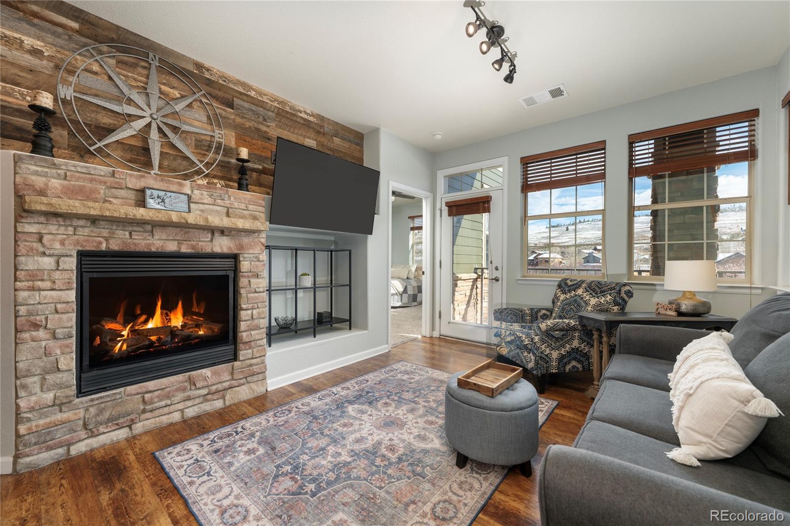 154 Village Road, Unit C103 Granby, CO 80446 - Photo 3 of 39 a living room with furniture and a fireplace