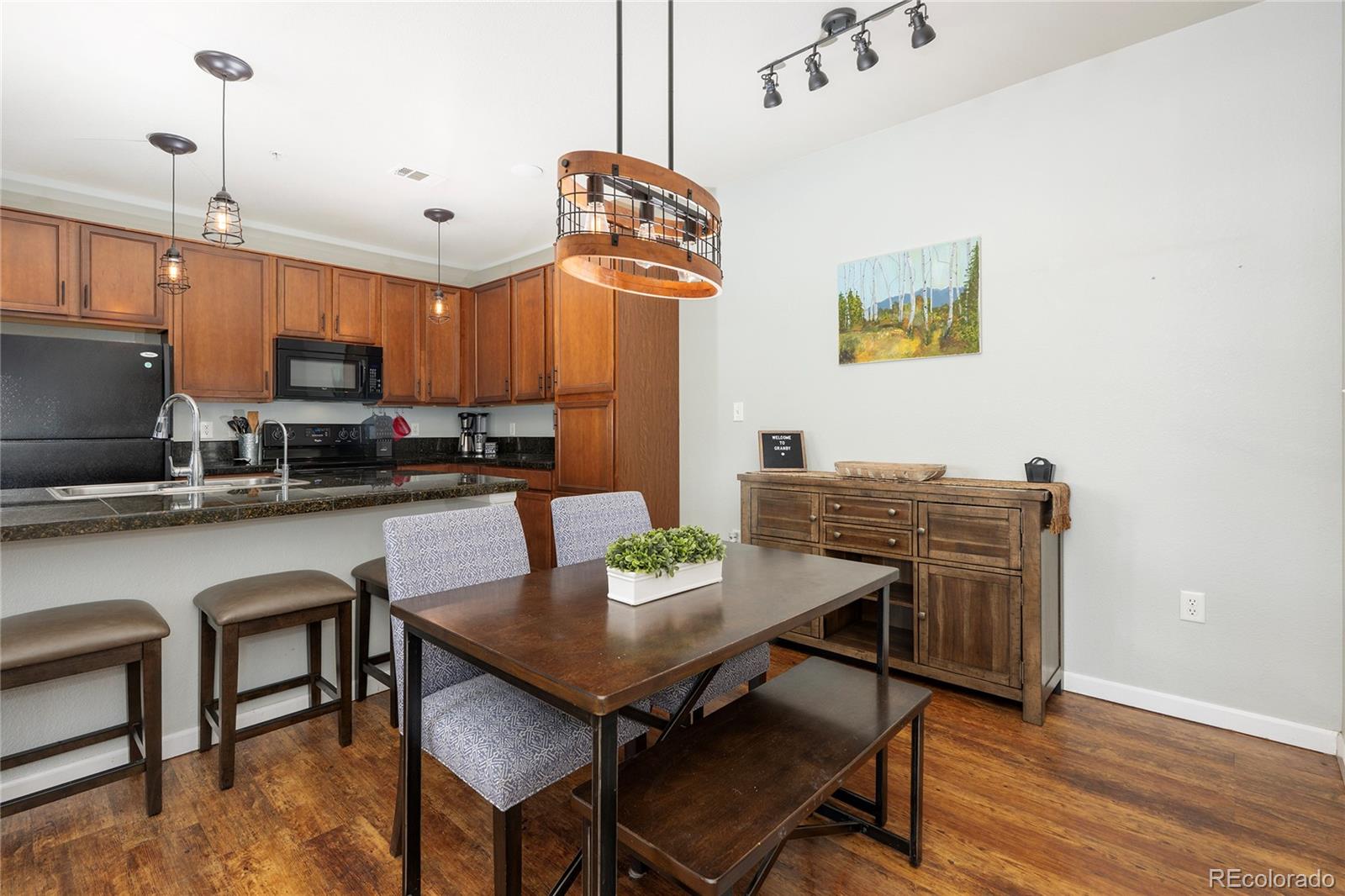 154 Village Road, Unit C103 Granby, CO 80446 - Photo 6 of 39 a view of a dining room with furniture and wooden floor