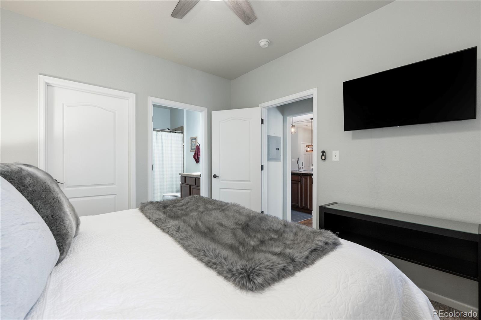 154 Village Road, Unit C103 Granby, CO 80446 - Photo 7 of 39 a bedroom with a bed and a flat screen tv