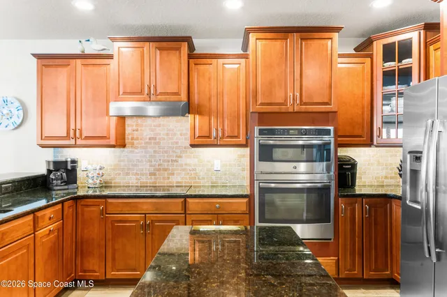 a bedroom with a bed and a view of living room
