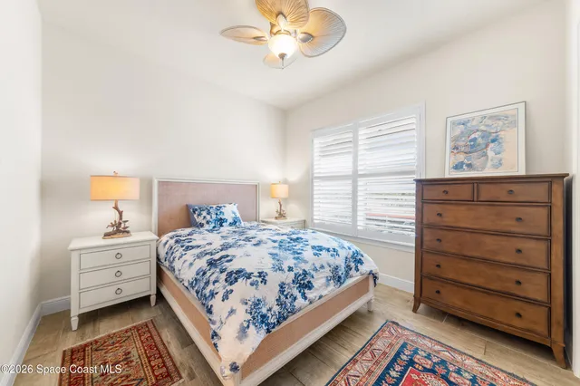 a bathroom with a granite countertop sink toilet a mirror and shower