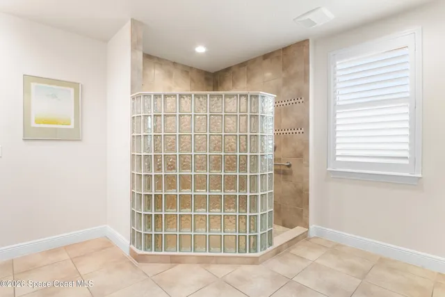 a view of a livingroom with furniture a ceiling fan and window