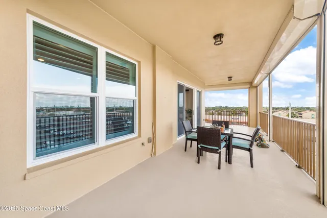 a living room with furniture a clock and wooden floor